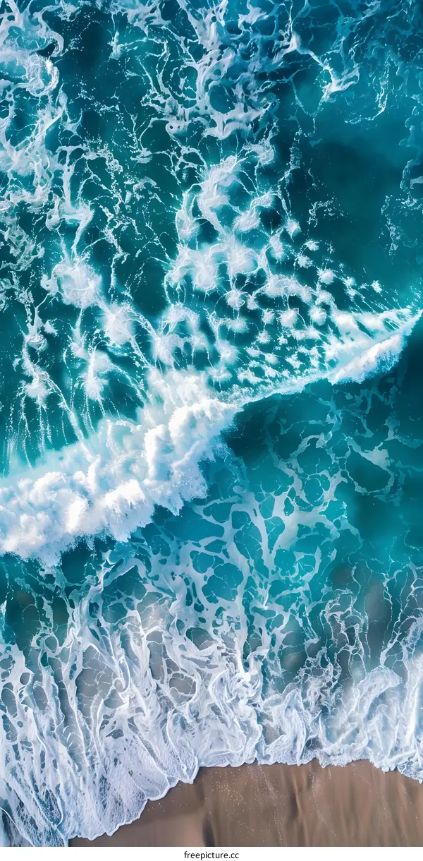 Aerial View of Ocean Waves Crashing on Sandy Beach