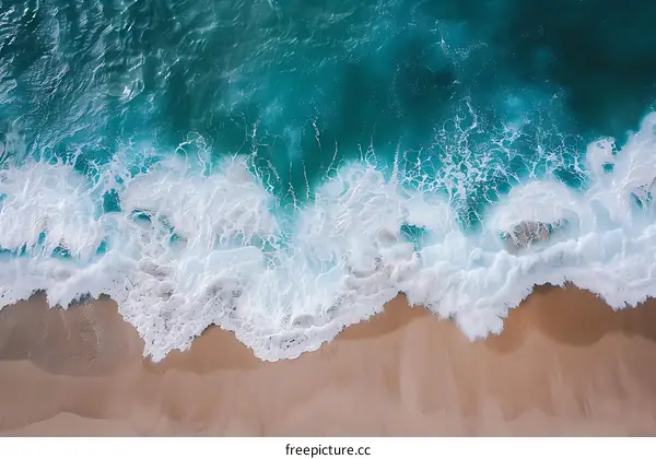 Aerial View of Ocean Waves Crashing on Sandy Beach