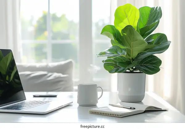 A Bright Home Office Workspace with a Laptop, Coffee Cup, Notebook, and Potted Plant