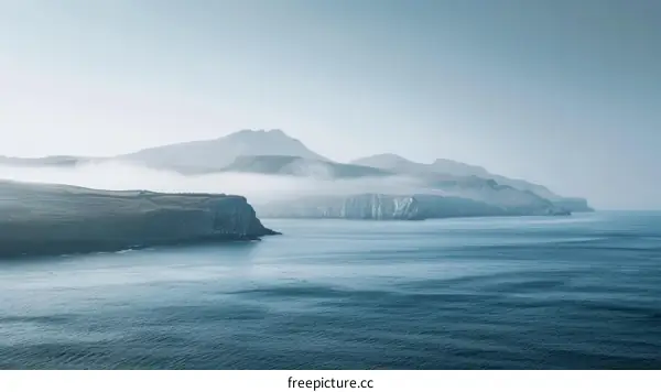 Misty Mountain Peaks Above the Ocean