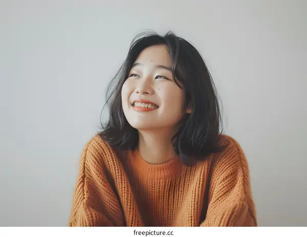 Smiling Woman with Short Hair Wearing an Orange Sweater