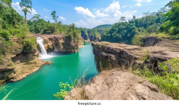 A stunning view of a waterfall in the middle of a lush green forest