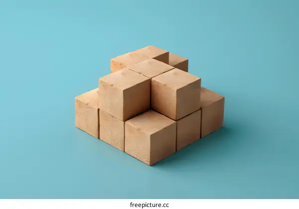 Wooden Cubes Stacked in a Pyramid Shape on Blue Background