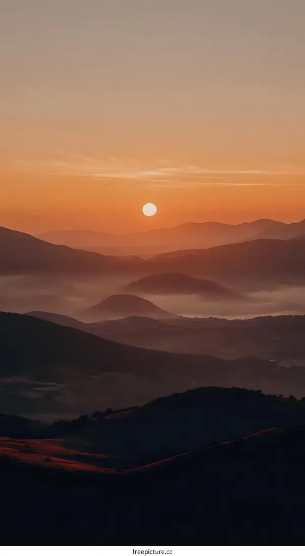 Sunrise Over Mountain Range with Fog