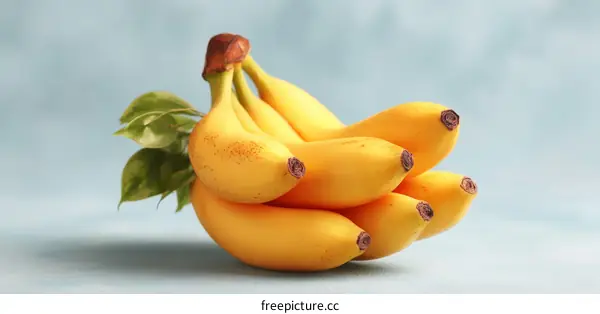 Bunch of Ripe Bananas on Light Blue Surface