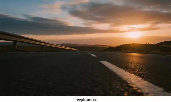 Sunset over an empty road with clouds and golden light