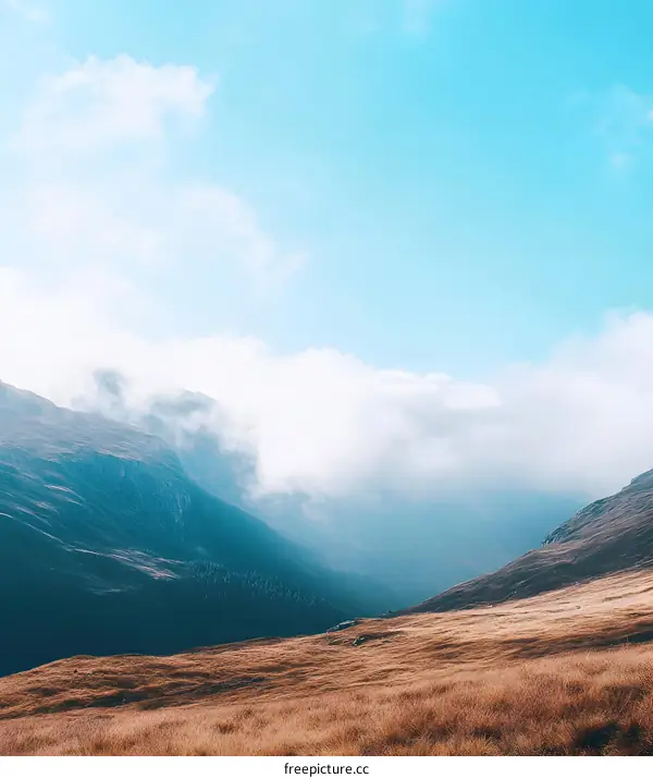 Mountain Landscape with Clouds and Grass Field