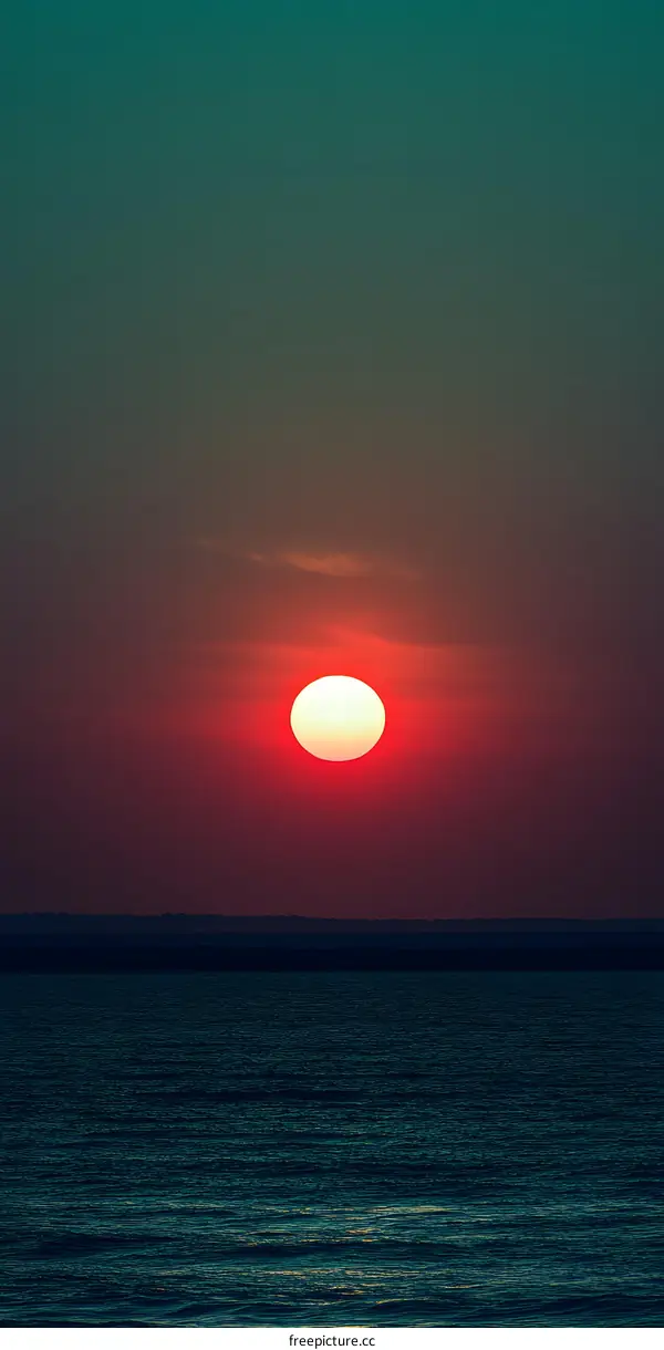Sunset Over Ocean With Dark Blue Skies