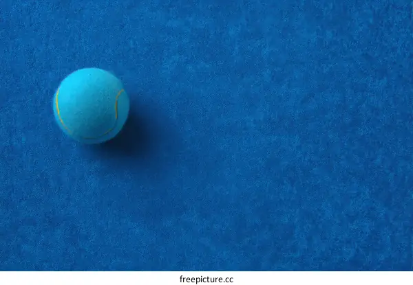 Single Tennis Ball on Blue Background