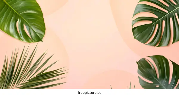 Green Tropical Leaves on Pink Background