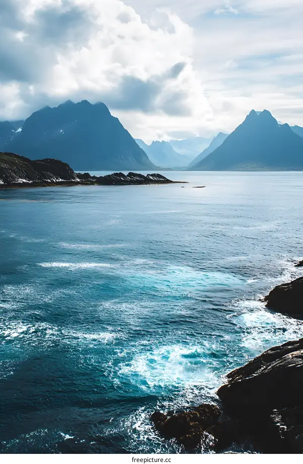 Mountain Range Surrounded by Blue Water