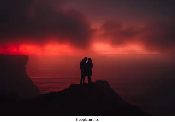 Silhouettes of Couple at Sunset Overlooking the Ocean