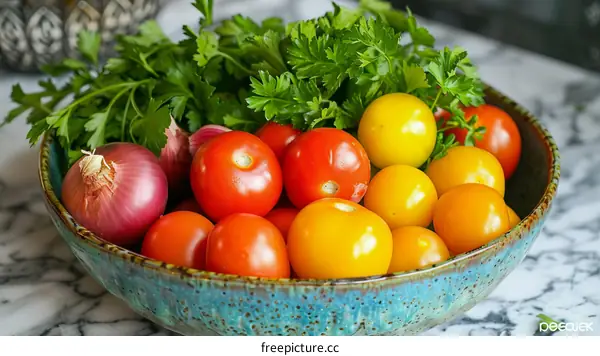 A bowl of red, yellow, and orange tomatoes with parsley and shallots