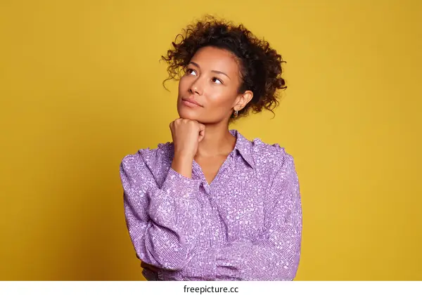 Thoughtful Black Woman in Purple Blouse