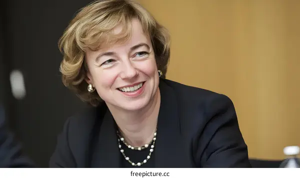 Portrait of a Smiling Woman in a Black Suit