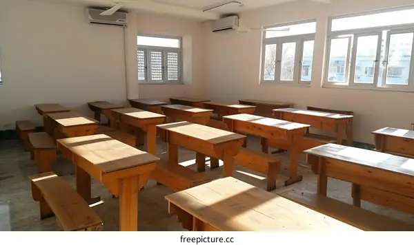An Empty Classroom With Wooden Desks And Benches
