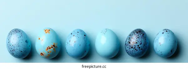 Pastel Blue Easter Eggs on a Light Blue Background