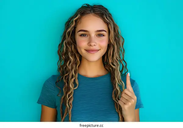 Smiling Woman with Curly Hair Pointing