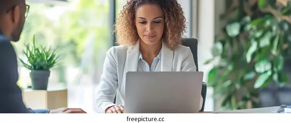 African American Woman Working on Laptop in Modern Office