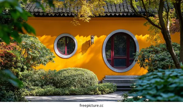 Traditional Chinese Architecture with Yellow Wall and Round Window