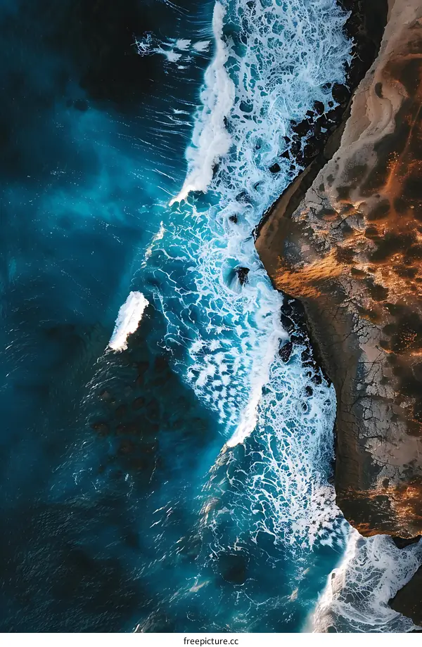 Aerial View of Waves Crashing on Rocky Coastline