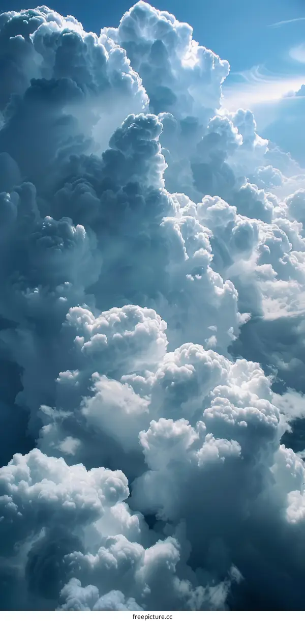 A large white and gray cloud with a blue sky background