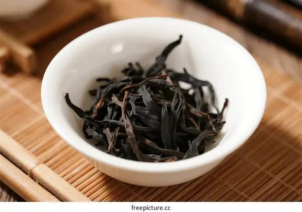 A Cup of Dry Black Tea Leaves in a White Ceramic Bowl