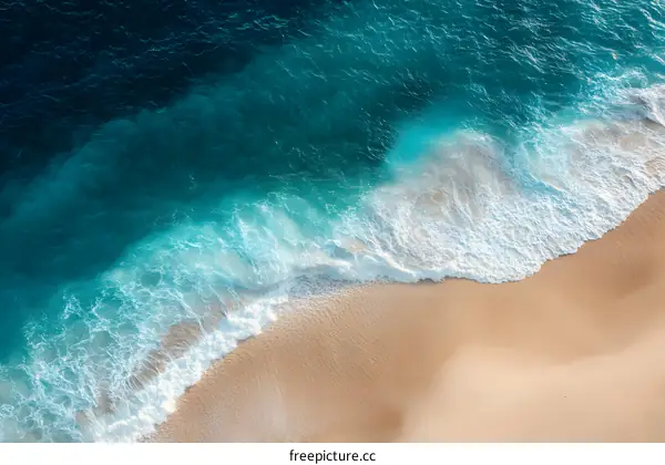Aerial View of Ocean Waves Crashing on Sandy Beach
