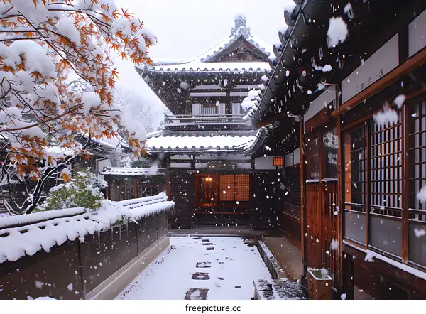 A traditional Japanese house with a snow covered garden