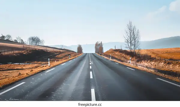 Empty Road Leading Through Hills