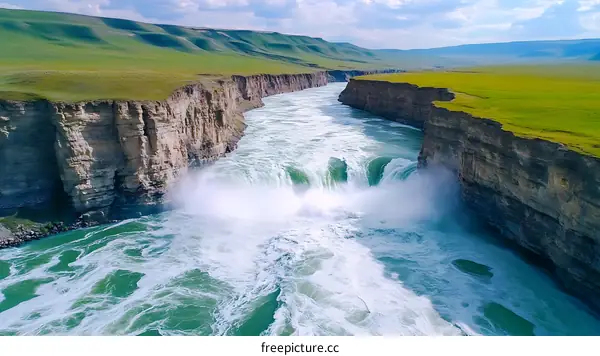 Majestic Waterfall Cascading Through Canyon Landscape