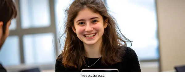 Smiling young woman in casual clothing with a blurred background