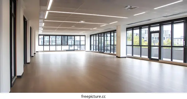 Modern Office Space with Large Windows and Wood Flooring