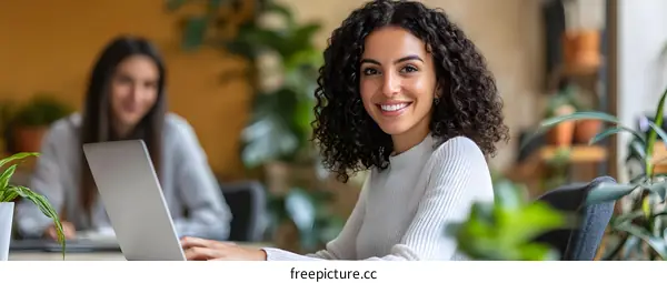 Smiling Woman Working On Laptop In Office