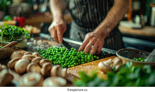 Chef Preparing Green Peas on a Wooden Cutting Board