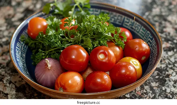 A bowl of fresh tomatoes and parsley