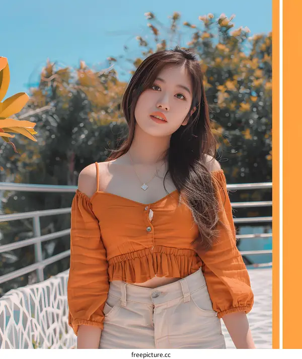 Portrait of a Young Woman in an Orange Top and White Jeans