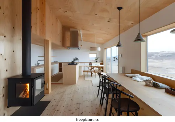 Modern Kitchen and Dining Room With Wood Accents and a View