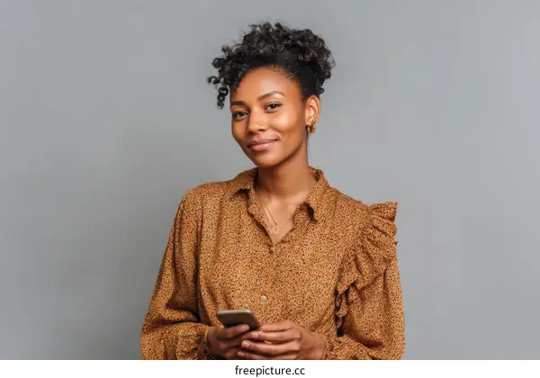 Confident African American Woman Holding Smartphone