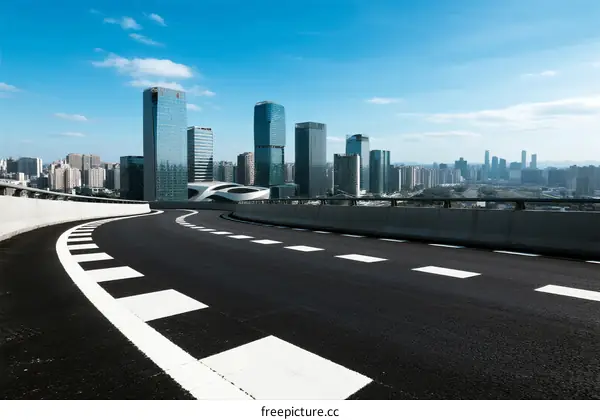 Modern city road with skyscrapers under clear blue sky
