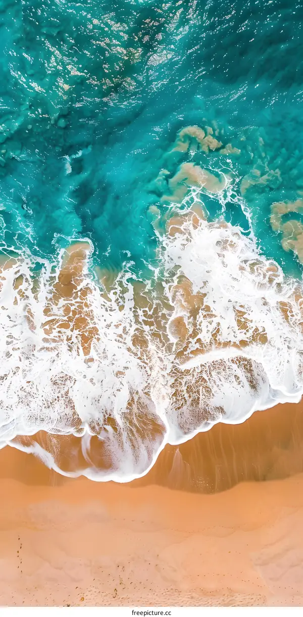Aerial View of Ocean Waves Crashing on Sandy Beach