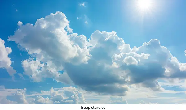 Serene Blue Sky with White Clouds and Sun