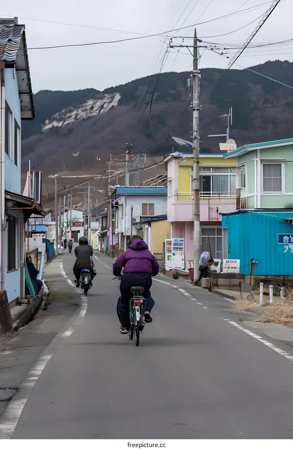 People Riding Bikes on a Street in Japan