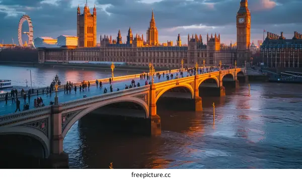 People walking on bridge with city skyline in background