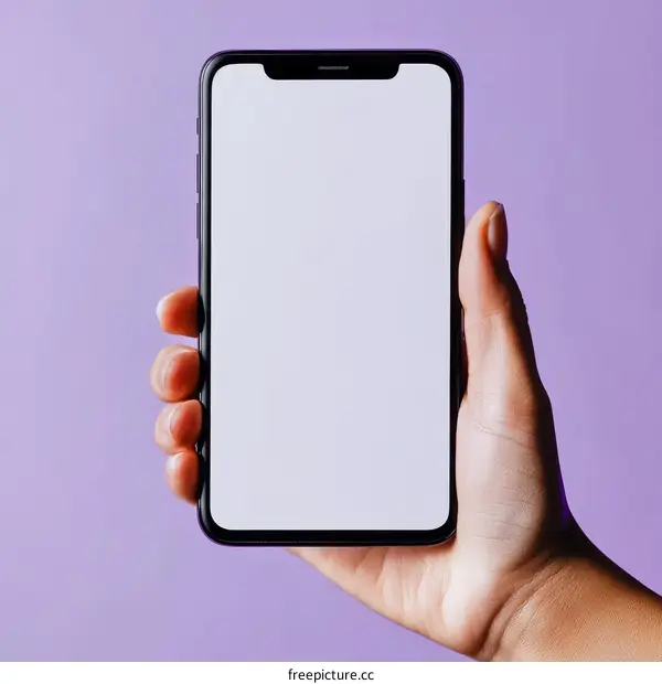 Hand Holding Smartphone with Blank Screen on Purple Background