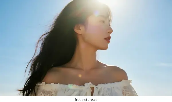 A Young Woman Standing Under Bright Sunlight with Long Hair