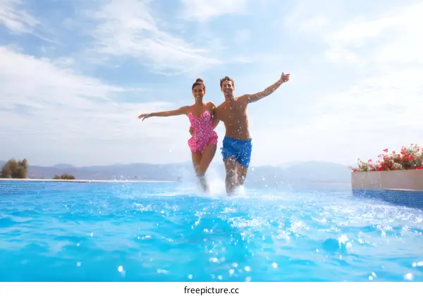 Couple Running Through a Swimming Pool