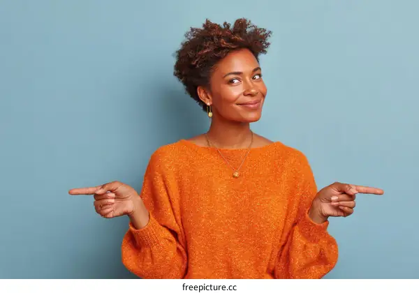 Woman in Orange Sweater Pointing to the Right