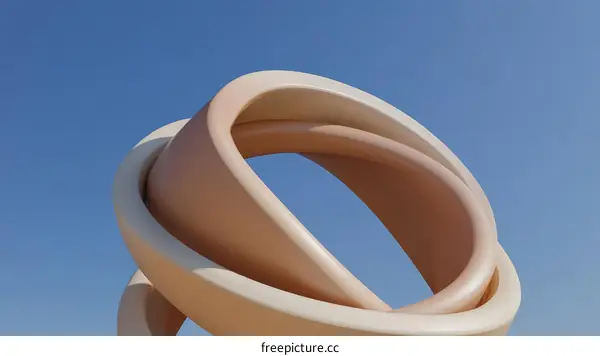 Abstract Intertwined Rings against a Clear Sky