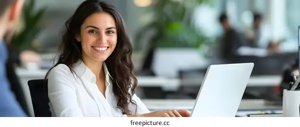 Smiling Woman Working On Laptop In Office